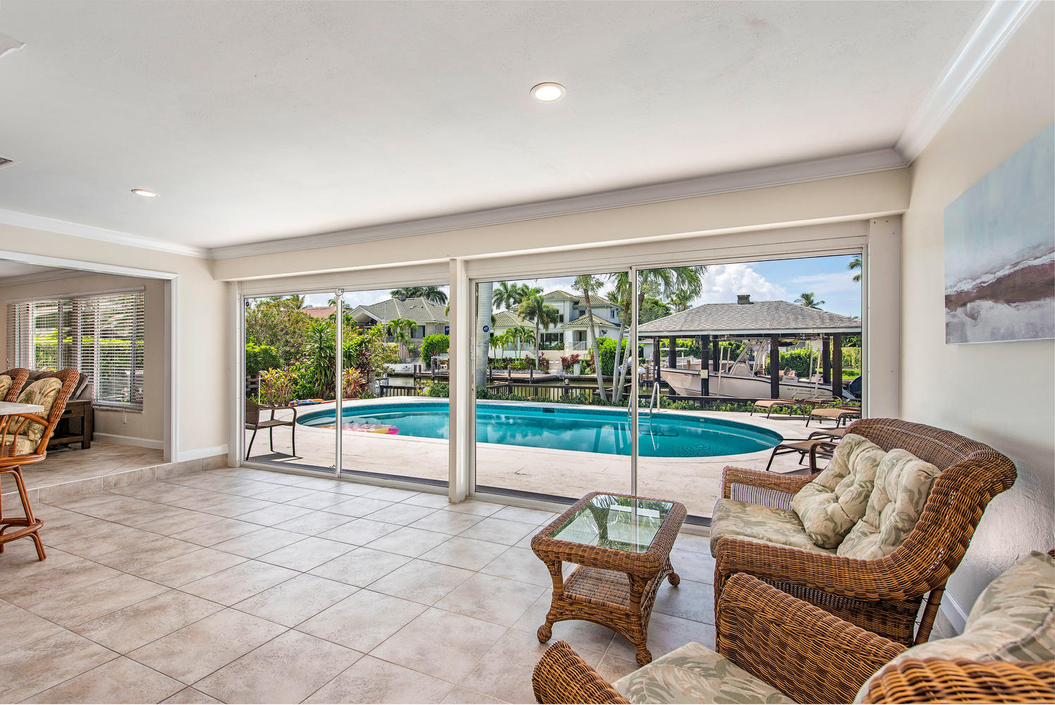 Sitting area with view of pool and canal at Naples vacation rental house